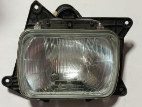 FAMILIA JEEP 7R0188701 - FARO IZQUIERDO PARA JEEP CHEROKEE XJ (1984 - 2001)  ÓPTICA